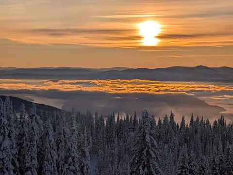 Low winter sun over cloud and snowy forest, SilverStar Mountain Resort, near Vernon, B.C., December 9, 2024