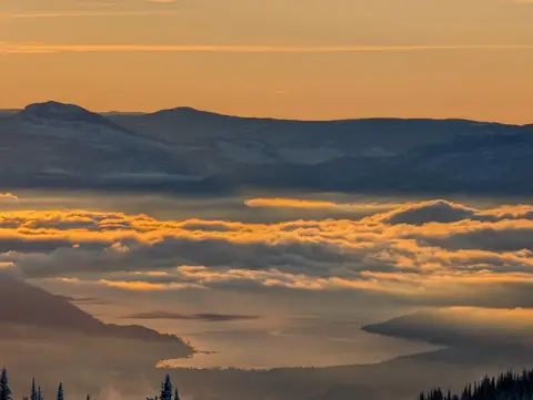 Golden cloud over the valley, lake far below, SilverStar Mountain Resort, near Vernon, B.C., December 9, 2024